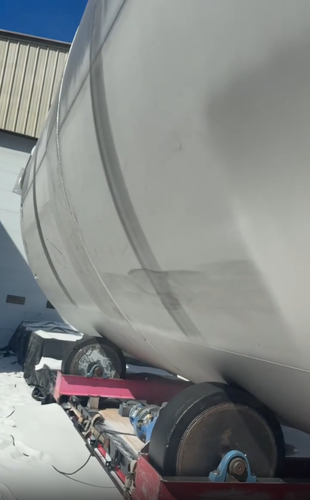 Abrasive blasting interior of water treatment tank